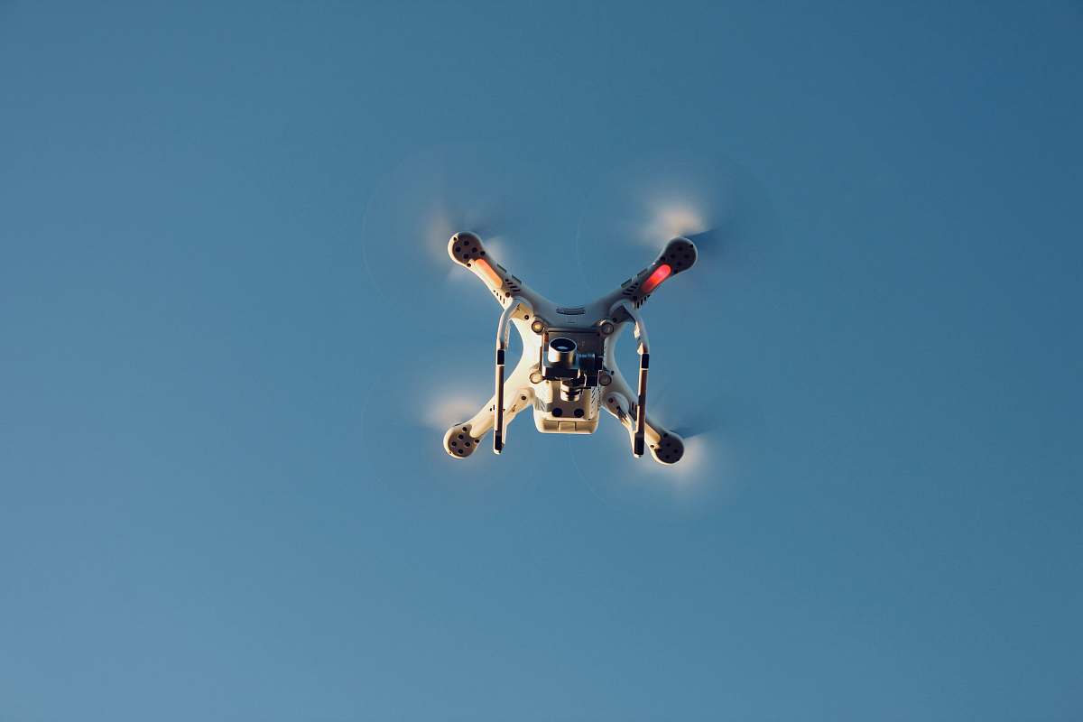 le roy low angle photography of RC quadcopter at mid air airplane